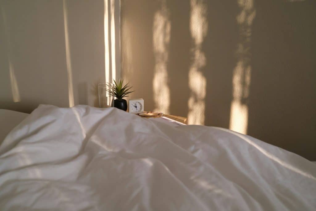 Clean bedroom with fresh bedding to help reduce dust mite exposure