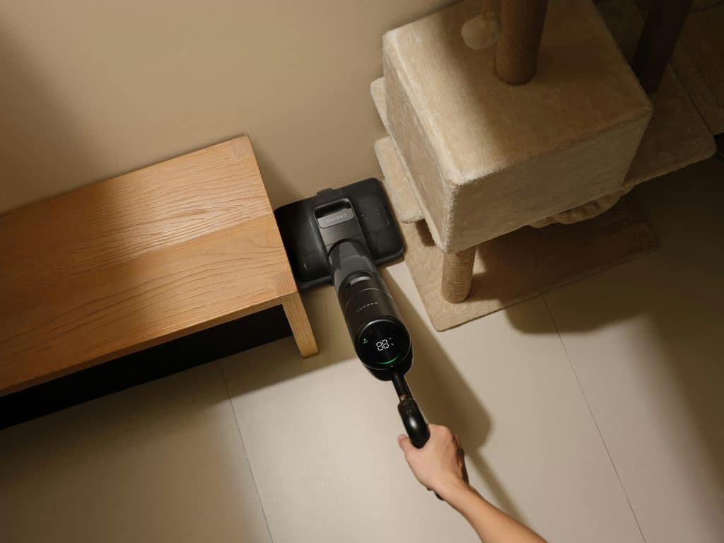 HEPA vacuum cleaner being used to clean a bedroom floor